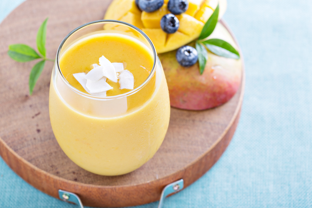 Mango smoothie fresh and bright on a board